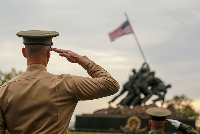 Service member saluting the American flag