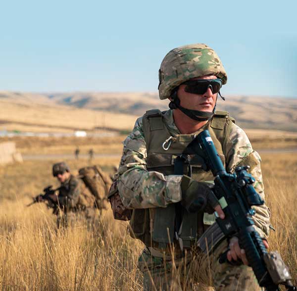 Service member in tall grass