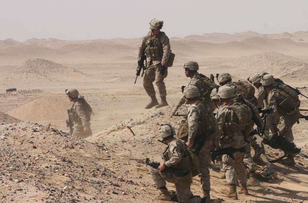 Service members in action in the desert