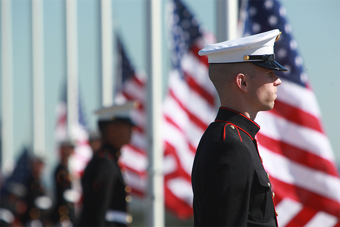 Marines standing in front of flags