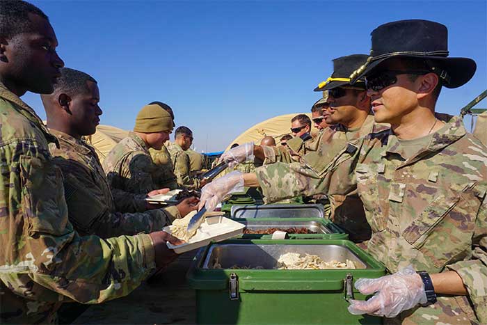 Service members enjoying a hot meal