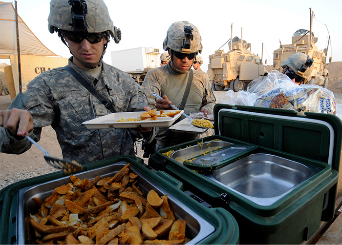 Deployed service members enjoying a hot meal