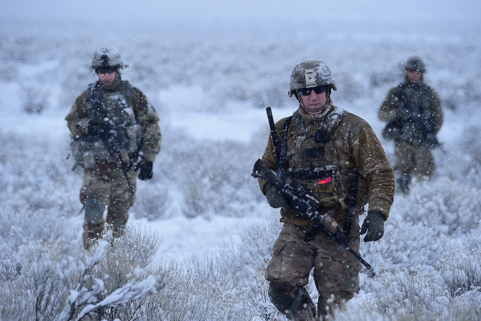 Service members working in the snow
