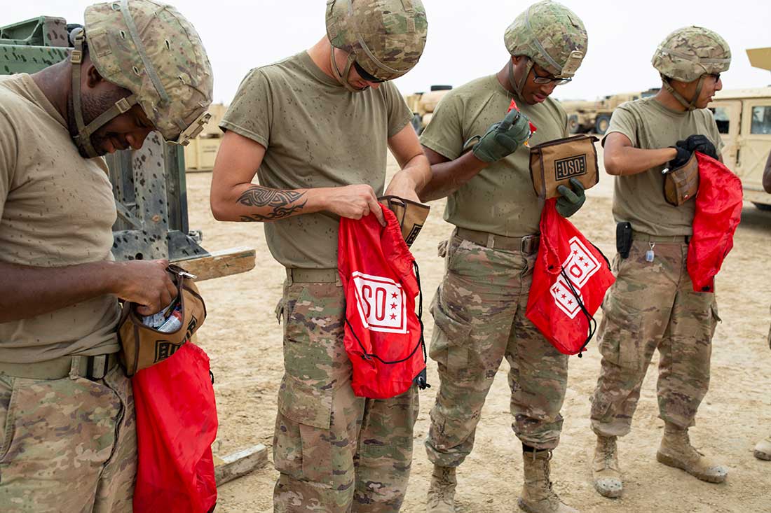 Service members opening USO care packages