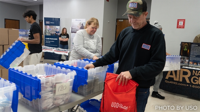 Employee volunteers from Mutual of Omaha Mortgage helping fill USO Holiday Care Packages for service members