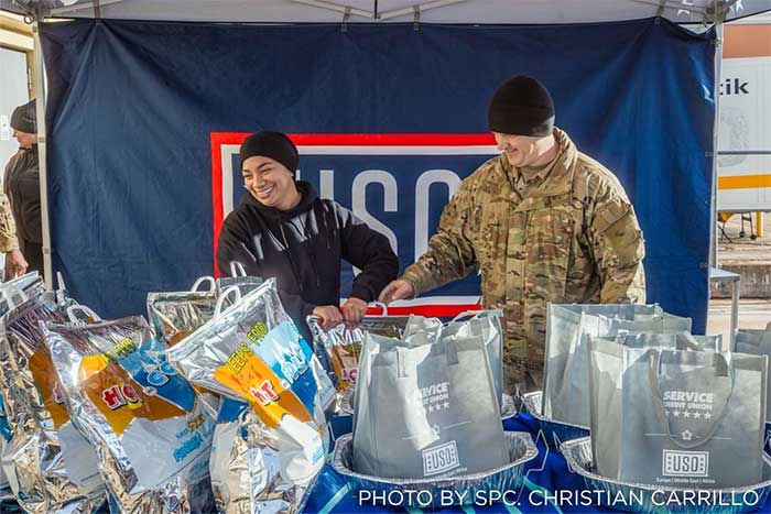 Service members enjoying a Thanksgiving Lunch prepared by USO staff and volunteers