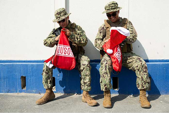 Service members opening USO Holiday Care Packages