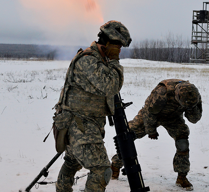 Service members in action in the snow