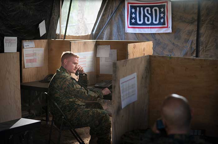 Service member on the phone at a USO facility