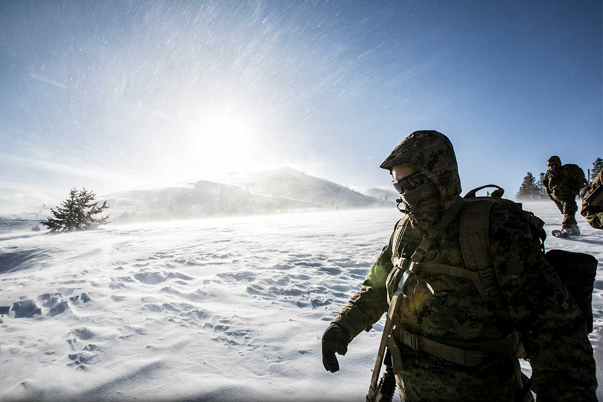 Service members walking in the snow