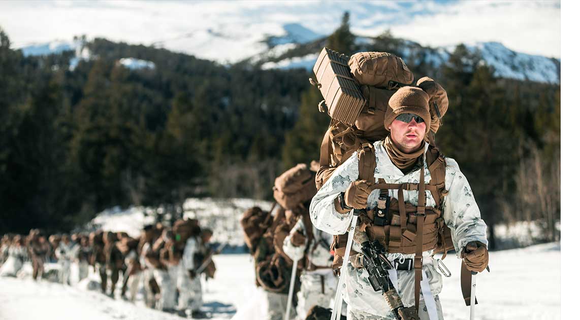 Service members in action in the snow
