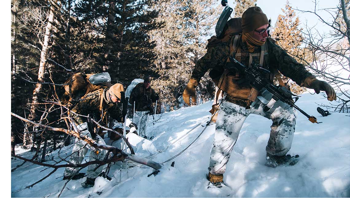 Service members in action in the snow