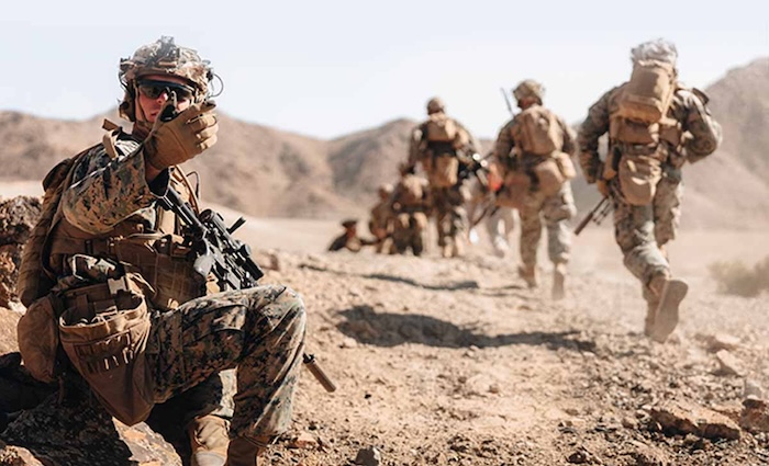 Service members in action in the desert