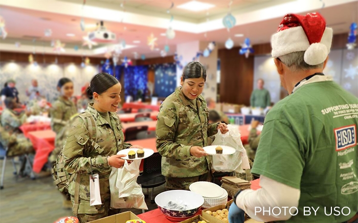 Service members enjoying a breakfast provided by the USO
