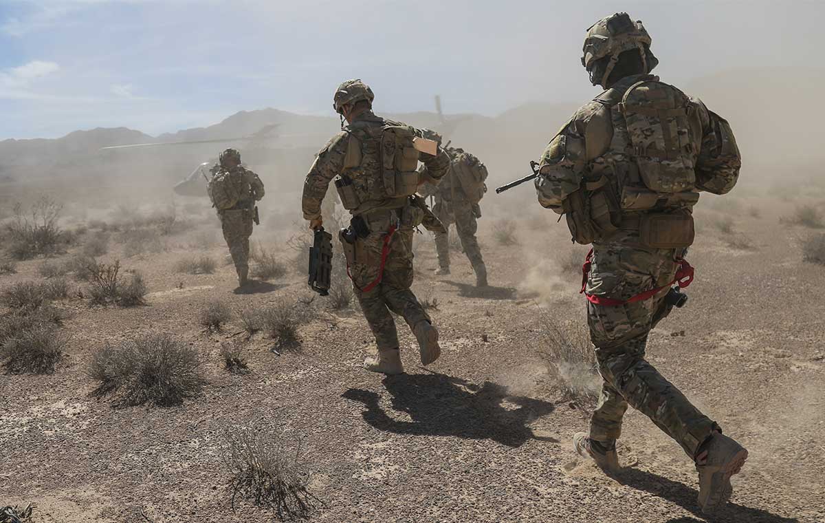 Service members in action in the desert