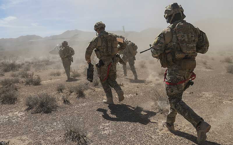 Service members in action in the desert